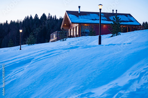Cottage on top of a snowy h...