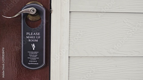door knob hanging with message note, communication sign message, please clean the room