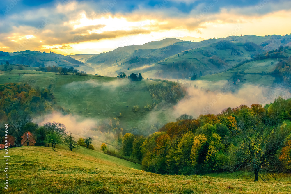 Beautiful scenery landscape Romania Holbav village mountains hills fields foggy morning