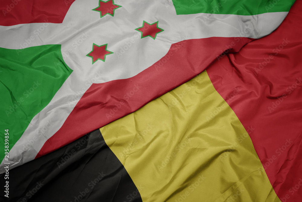 Fototapeta premium waving colorful flag of belgium and national flag of burundi .