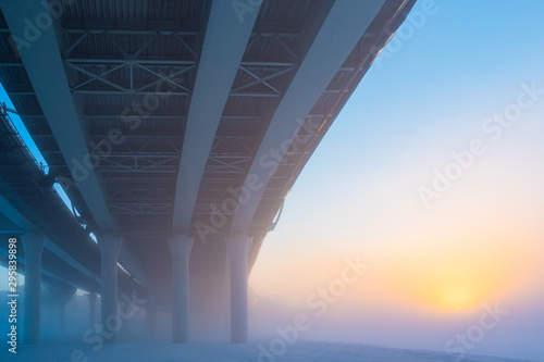 Bridges. City architecture. The bridge on the fon of dawn. The construction of bridges. Road architecture. Expressways on the bridges. Bridge piers. Bridge on the background of the rising sun