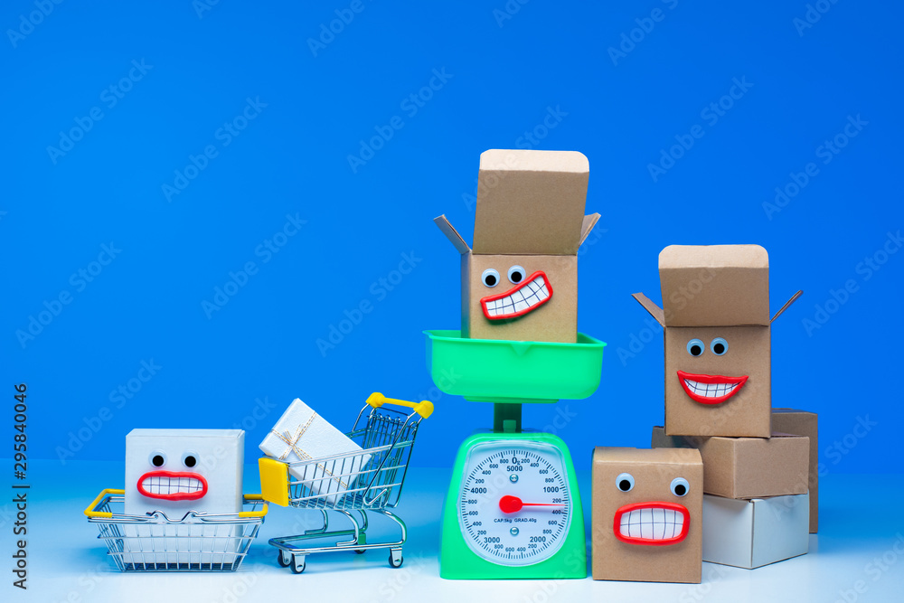 Obraz premium Cardboard boxes. Concept - weighting purchases. Weighing before purchase. Weighted goods. Boxes next to the scales. Opened boxes. Concept - Supermarket Products. Cart from the supermarket.