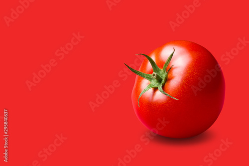 red tomato with a green stalk, on a red background, concept