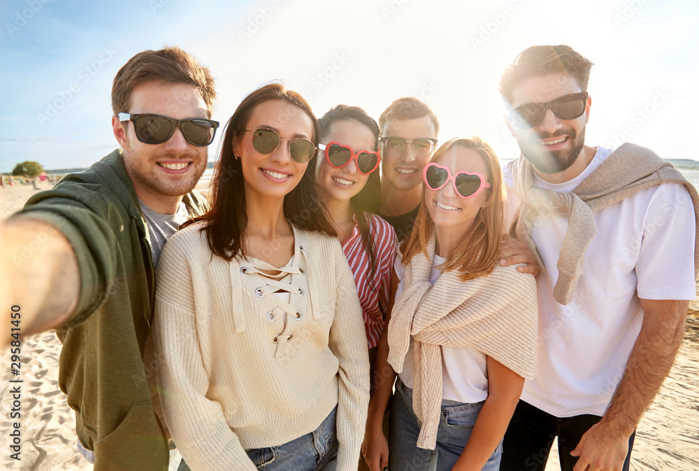 friendship, leisure and people concept - group of happy friends taking selfie on beach in summer friendship, leisure and people concept - group of happy friends taking selfie on beach in summer