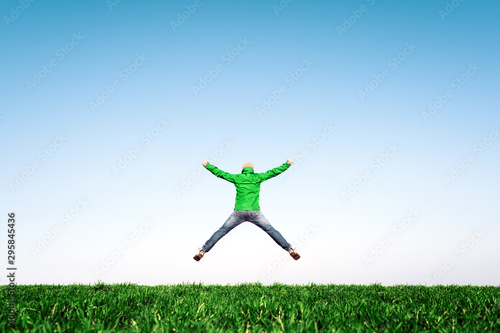 Man jump on amazing meadow in summer field. Success and happiness concept Man jump on amazing meadow in summer field. Success and happiness concept