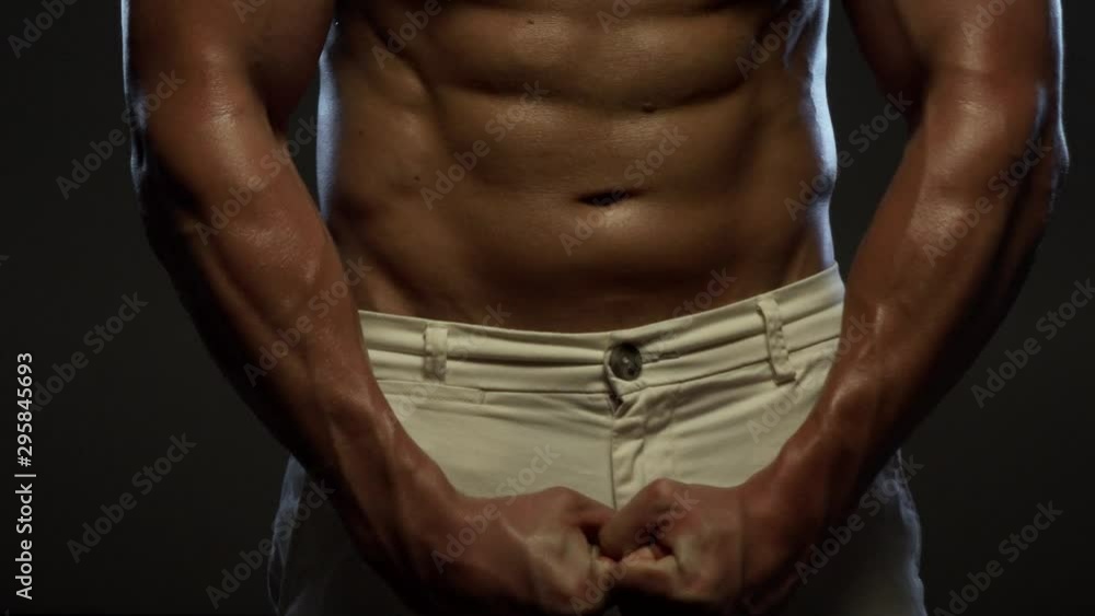 Fitness tanned guy showing muscles, close up Fitness tanned guy showing muscles, close up