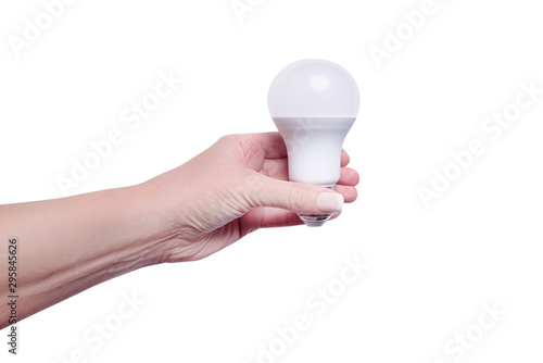 Woman hand holding energy saving lamp, isolated