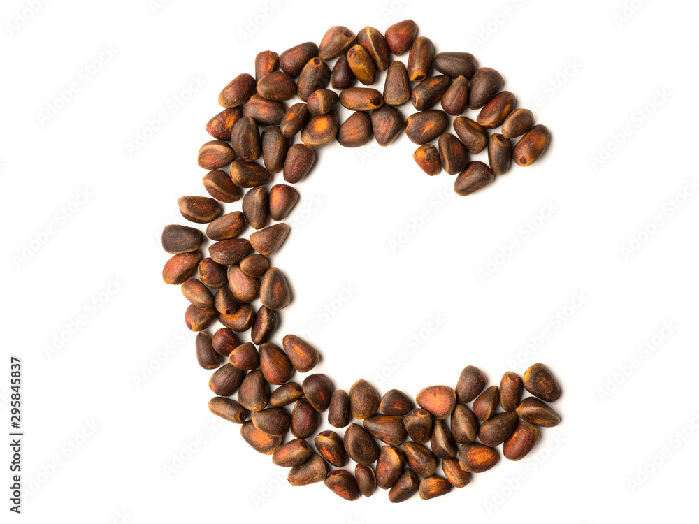 Isolated object: letter lined with ripe pine nuts Isolated object: letter lined with ripe pine nuts
