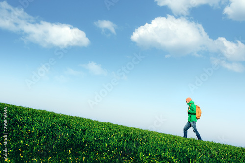 Tourist pitch a tent in summer mountains. Amazing green highland. Landscape photography