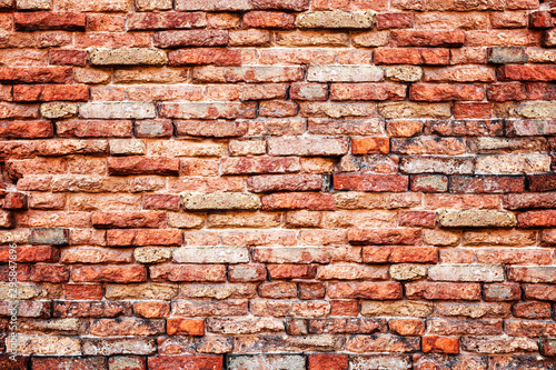 Old orange brick wall background with aging and rustic texture