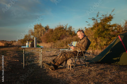 camping, male tourist enjoys the sunset, holiday by the sea