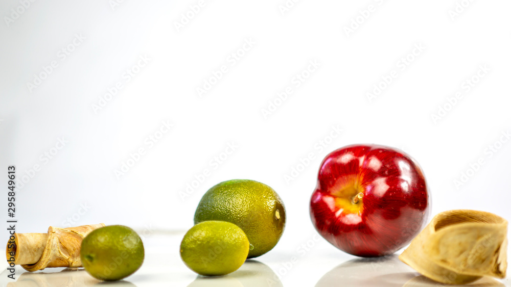 fresh green lemon and apples on white background fresh green lemon and apples on white background