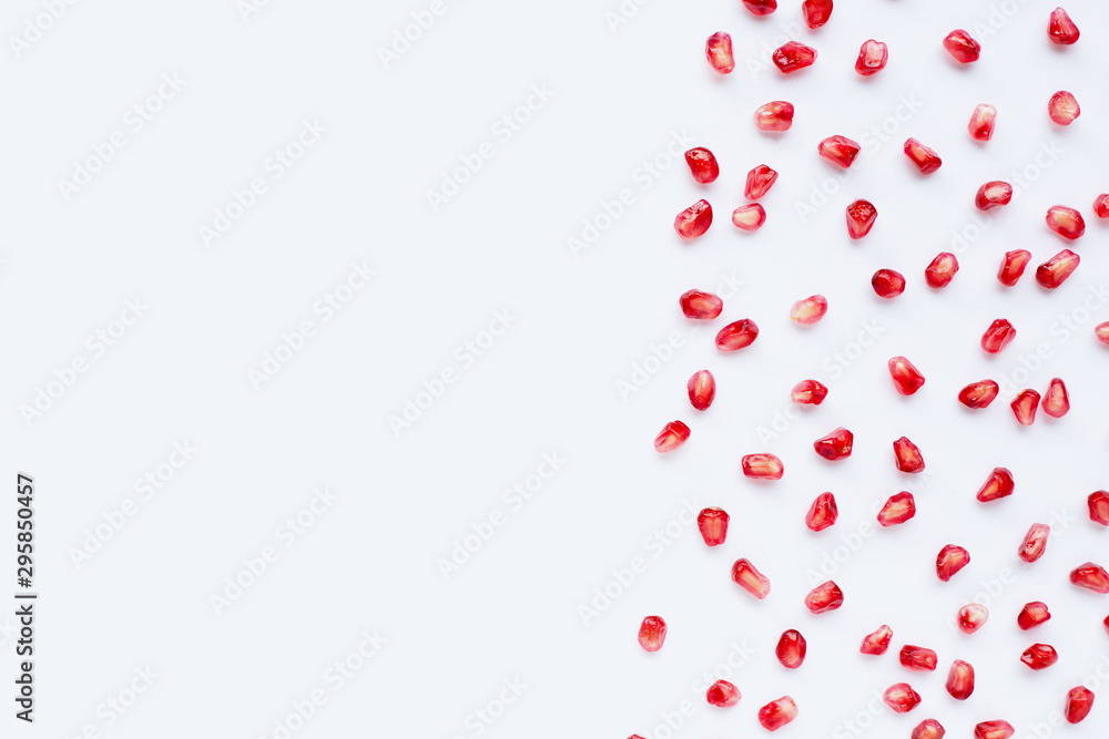 Pomegranate seeds on white background.