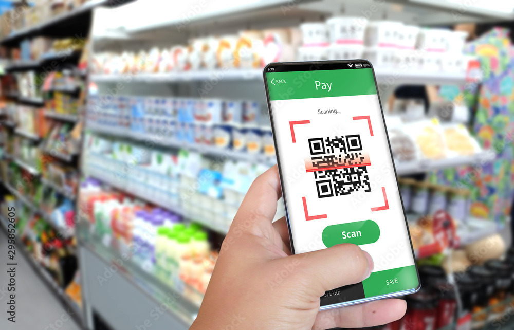 Hand holding smartphone to scan QR code payment , online shopping , cashless technology . Hand holding smartphone to scan QR code payment , online shopping , cashless technology .