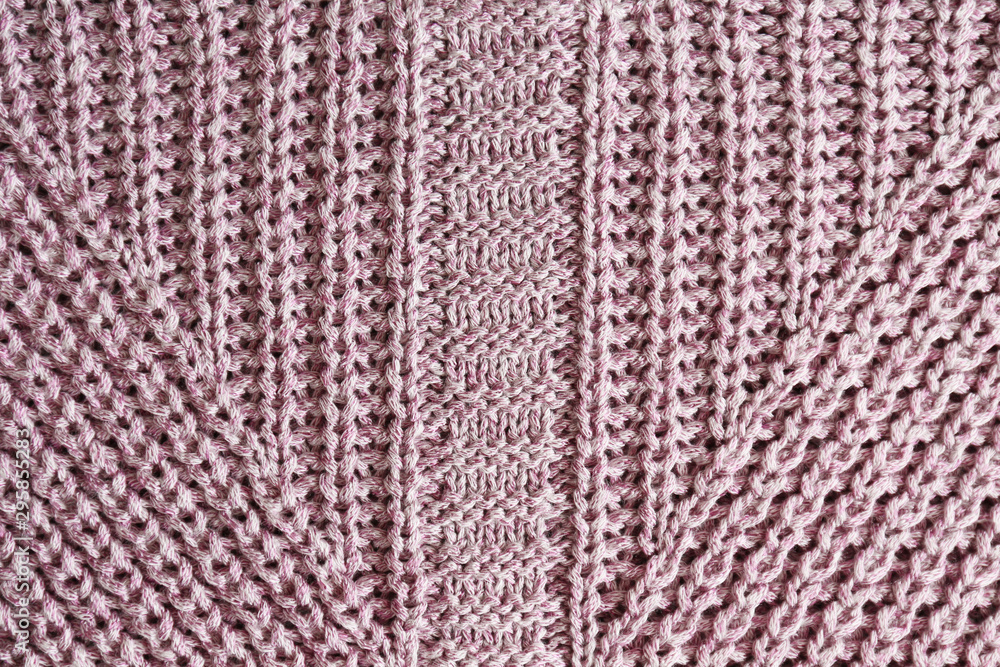 Cropped close up shot of seamless woolen knitting pattern of fall / winter season warm sweater, clearly visible fiber texture of stylish hipster knitwear clothing. Background, copy space, top view.