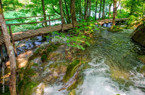 Picturesque landscapes of Plitvice Lakes with waterfalls  mountain rivers  forests and mountains