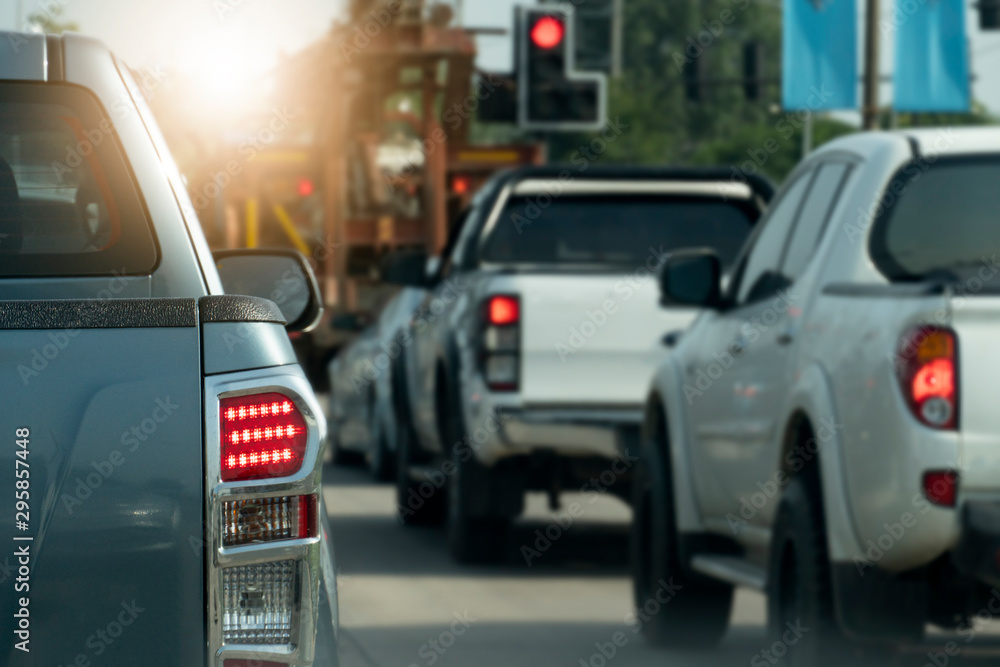 Luxury of pickup gray car stop on the junction by traffic light control in across. Traveling in the provinces during the bright period. Open light brake. with many cars.