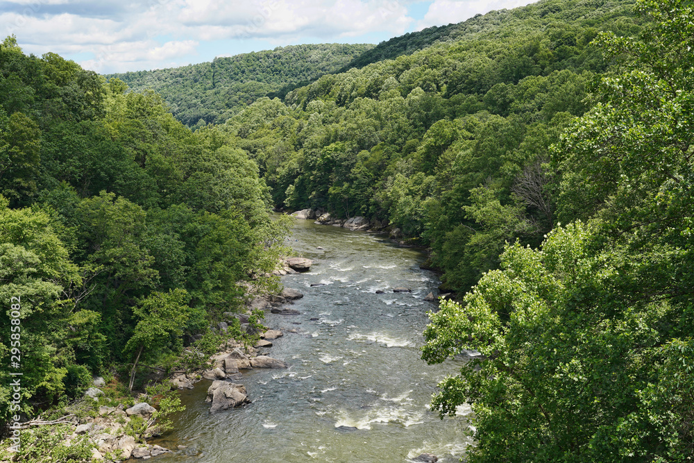 River going through the mountains at the Ohiopyle State Park in Pennsylvania. River going through the mountains at the Ohiopyle State Park in Pennsylvania.