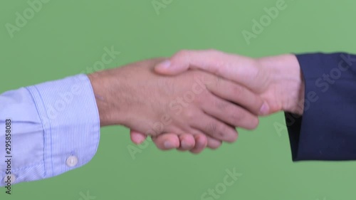 Hands of two multi ethnic businessmen shaking hands together