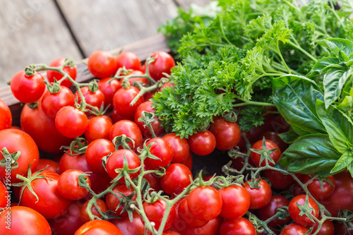 Cherry tomatoes in old wooden tray.