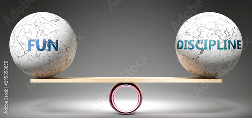 Fun and discipline in balance - pictured as balanced balls on scale that symbolize harmony and equity between Fun and discipline that is good and beneficial., 3d illustration photo