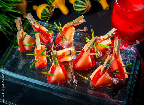 Slices of Patagonian toothfish fillet marinated in beet brandy with marinated baked bell pepper photo