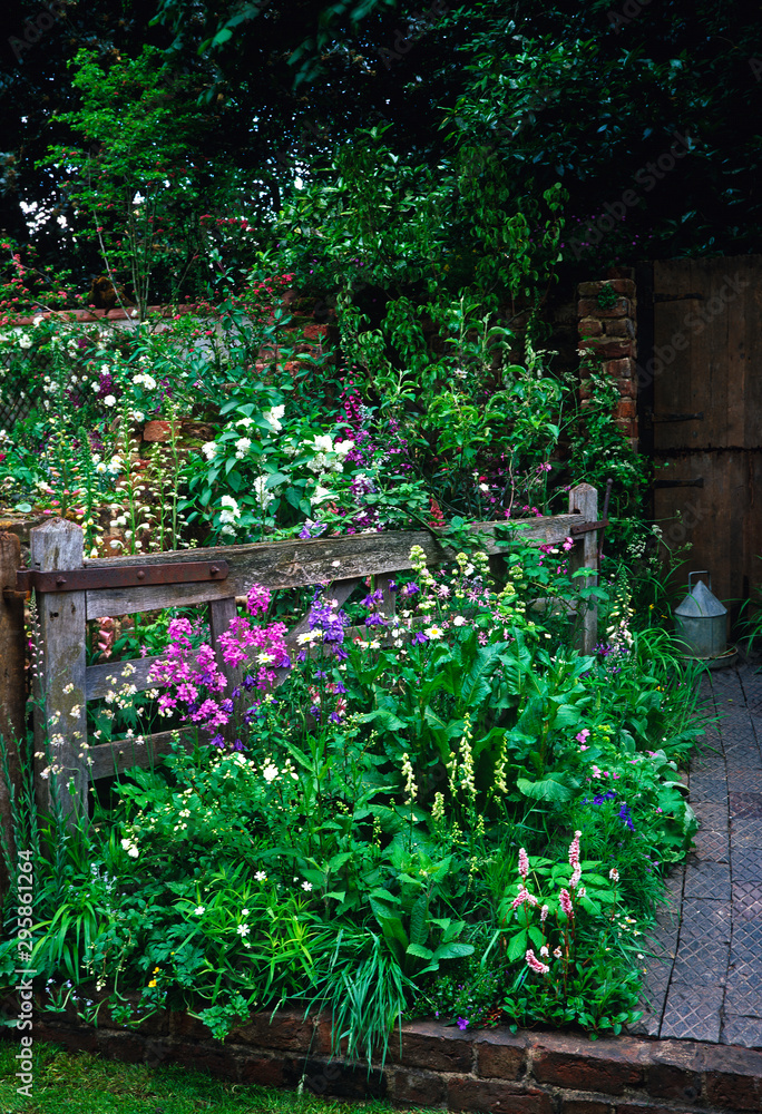 'The Old Gate' farmyard garden with natural planted flower border 'The Old Gate' farmyard garden with natural planted flower border