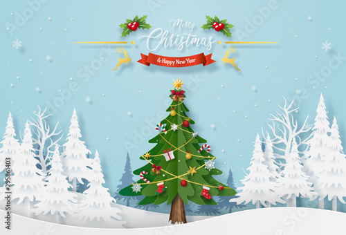 Origami paper art of Christmas tree with decoration in the forest with snowing, Merry Christmas and Happy New Year