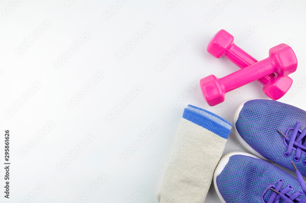 Fitness concept background with sneakers, dumbbells and towel. Top view with space for your text. Fitness concept background with sneakers, dumbbells and towel. Top view with space for your text.
