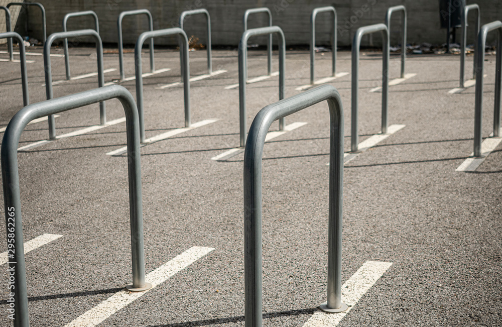 Fences linearly arranged in a public parking for bicycles and motorcycles Fences linearly arranged in a public parking for bicycles and motorcycles
