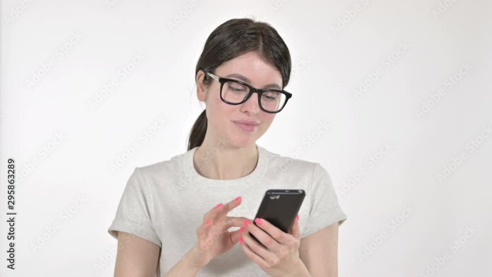 Attractive Young Woman using Mobile Phone on White Background Attractive Young Woman using Mobile Phone on White Background