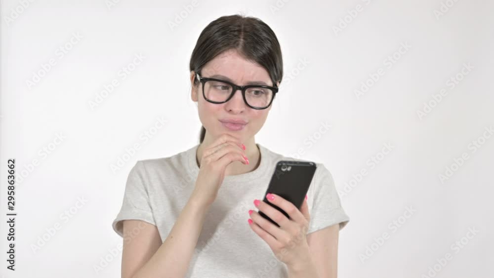 Sad Young Woman Feeling Disappointed While Looking at Phone on White Background Sad Young Woman Feeling Disappointed While Looking at Phone on White Background