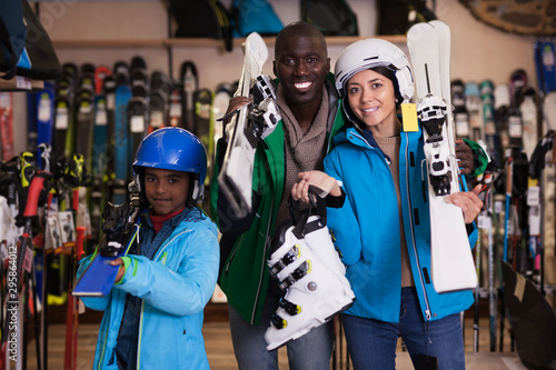 Multiracial family posing in skiing gear