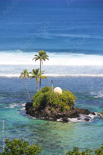 A small island in front the Seabreeze Resort Samoa. Samoa coastal aerial view. photo