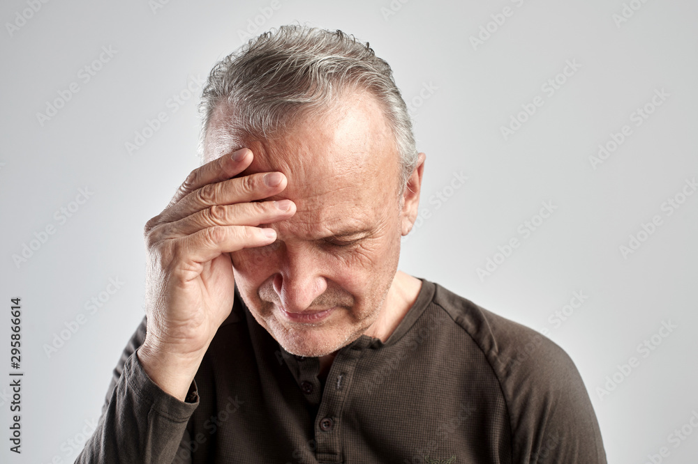 elderly gray-haired man with expression of pain on face put his hand on head, feels dizzy and cluster headache, migraine, high or low blood pressure isolated on white elderly gray-haired man with expression of pain on face put his hand on head, feels dizzy and cluster headache, migraine, high or low blood pressure isolated on white