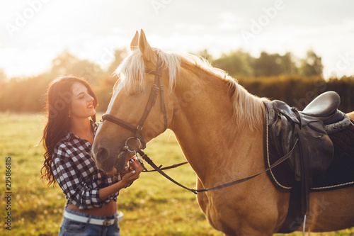 Beautiful young girl with her horse, autumn outdoors scene