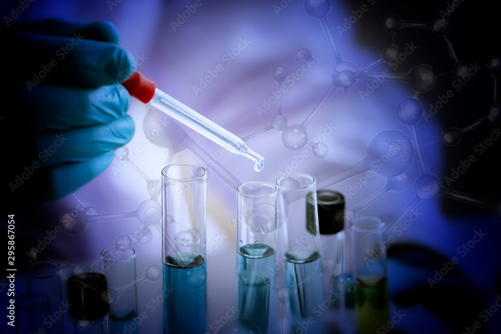 Laboratory concept; Scientist use dropper to transfer chemical reagent to test tube. He observe the chemical reaction in laboratory. Laboratory concept; Scientist use dropper to transfer chemical reagent to test tube. He observe the chemical reaction in laboratory.