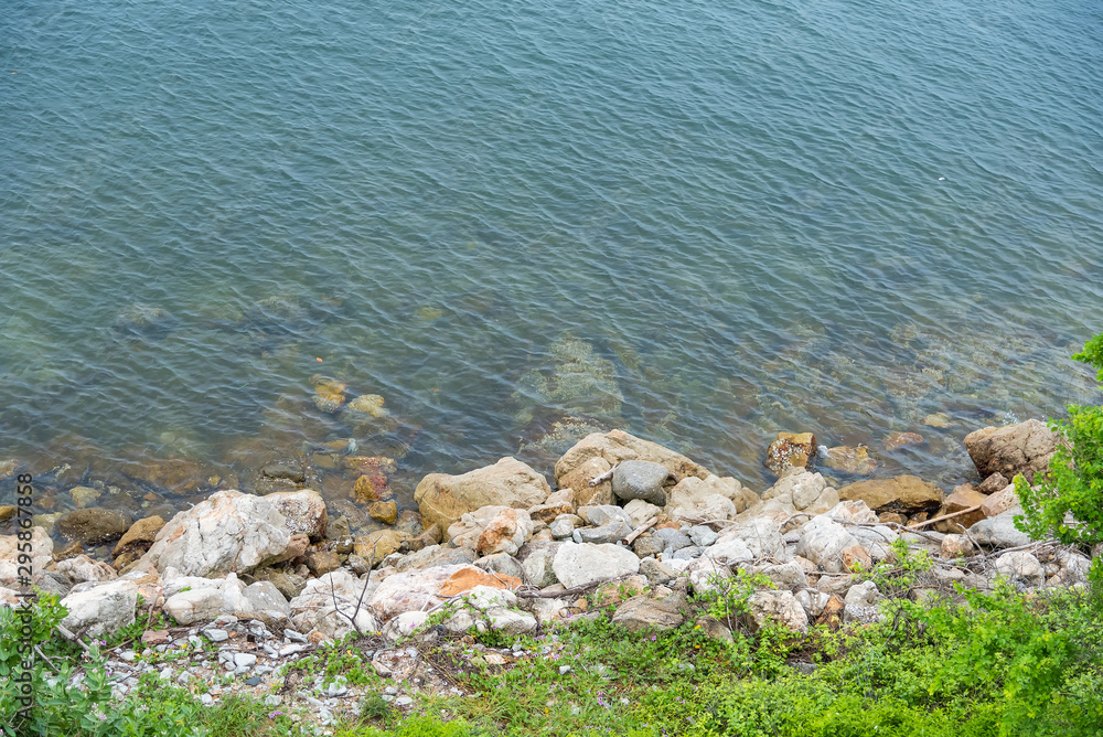 The rocky shore of the sea. Turquoise beautiful water. The rocky shore of the sea. Turquoise beautiful water.