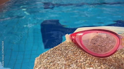 Swimming glasses and swimming pool background