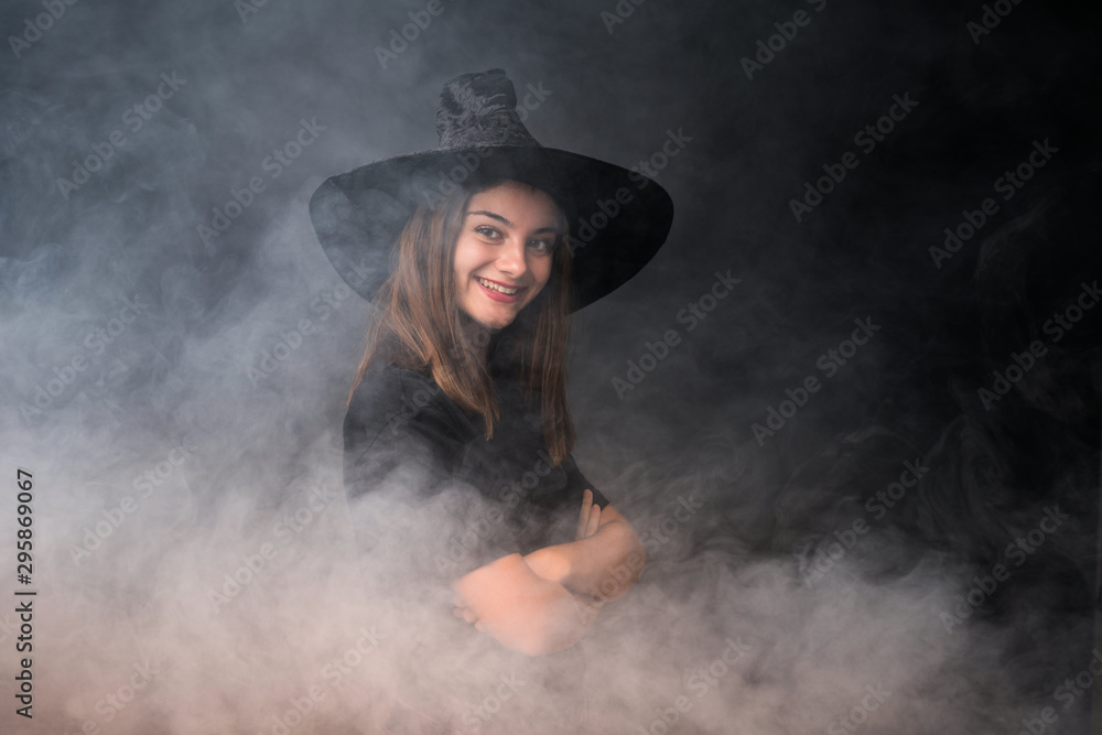 Young witch holding black and orange air balloons for halloween parties Young witch holding black and orange air balloons for halloween parties