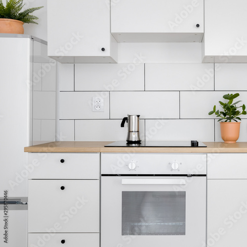 Contemporary kitchen with white tiles