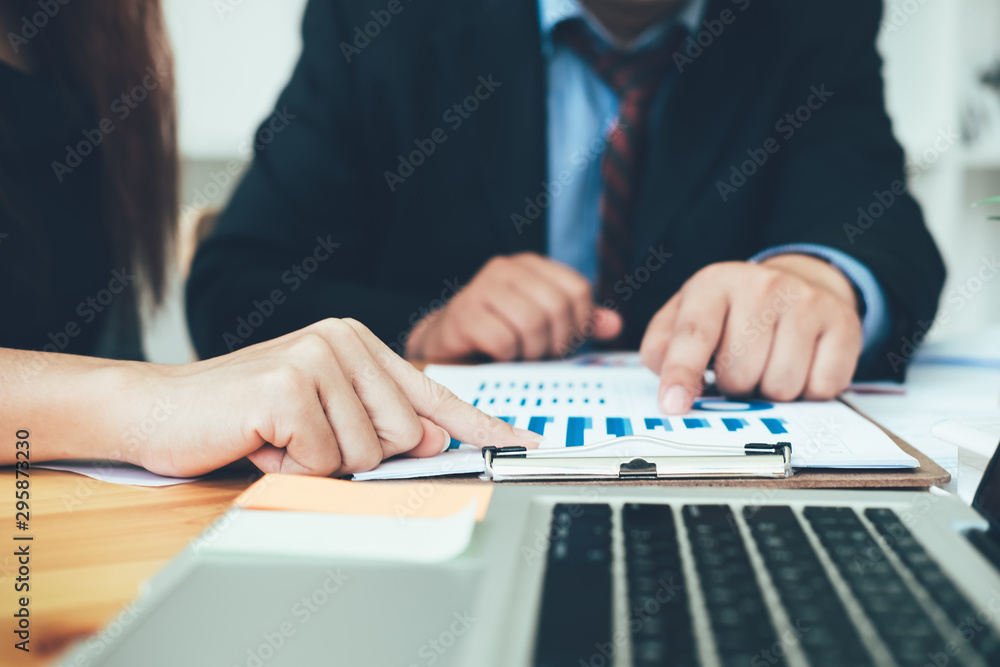 Business man supervising and secretary to execute business plan and consultant analyzing company annual financial report balance sheet statement working with documents graphs. Audit and consultant Business man supervising and secretary to execute business plan and consultant analyzing company annual financial report balance sheet statement working with documents graphs. Audit and consultant