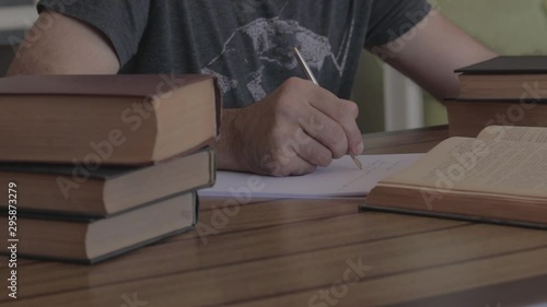 Man writing with pen on the table