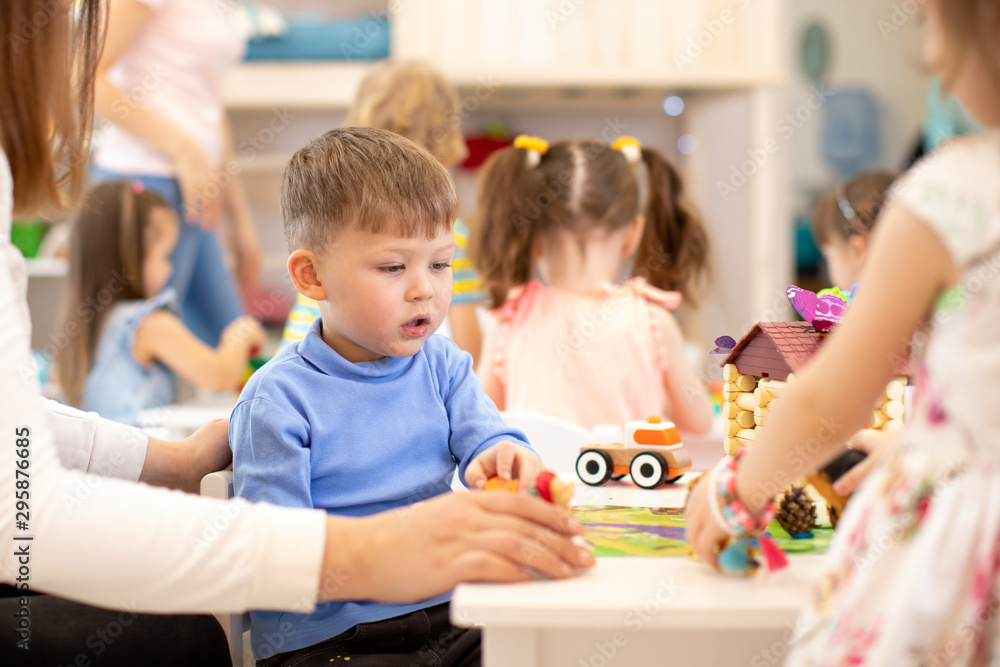 Group of kids on lesson in kindergarten or playschool Group of kids on lesson in kindergarten or playschool