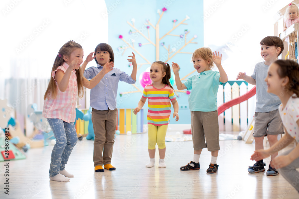 Group of happy children jumping in club. Kids playing together