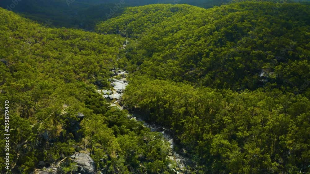 Aerial, a waterfall in the middle of rain forest at Davies Creek in Queensland, Australia Aerial, a waterfall in the middle of rain forest at Davies Creek in Queensland, Australia