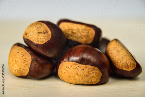 Castagne mature appena raccolte su tagliere bianco