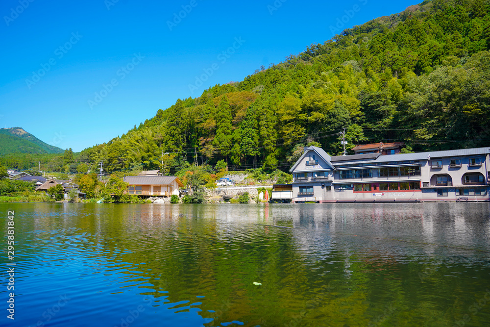 Lake Kinrin and Japanese gate (Torii) with Mount Yufu and blue sky background at Yufuin, Oita, Kyushu, Japan Lake Kinrin and Japanese gate (Torii) with Mount Yufu and blue sky background at Yufuin, Oita, Kyushu, Japan