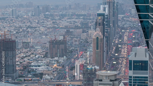 Skyscrapers on Sheikh Zayed Road and DIFC aerial day to night timelapse in Dubai  UAE.