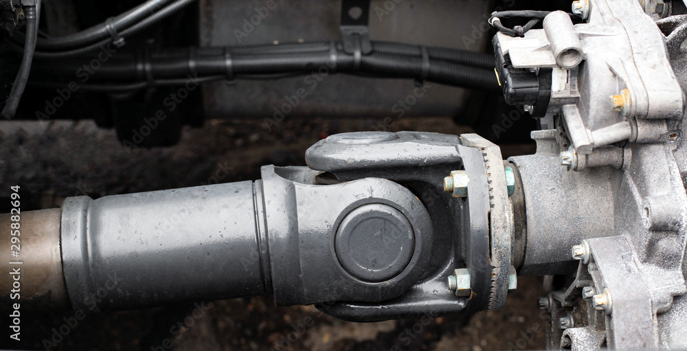 Cardan transmission of a truck transmitting torque. Drive shaft close-up, propeller shaft